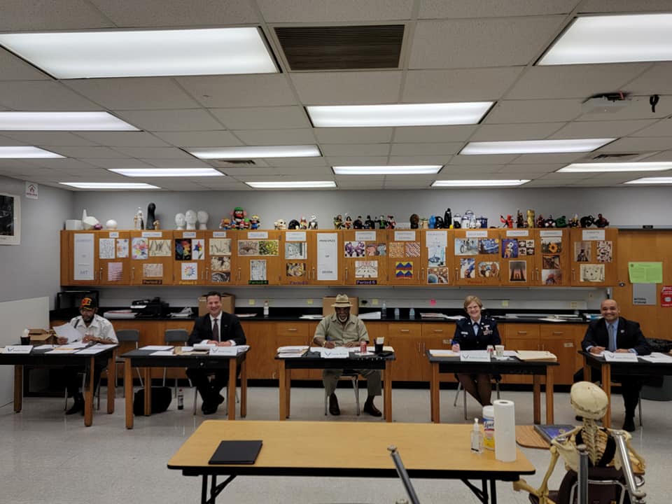 Julius Melendez seated with an Osceola County School Board panel