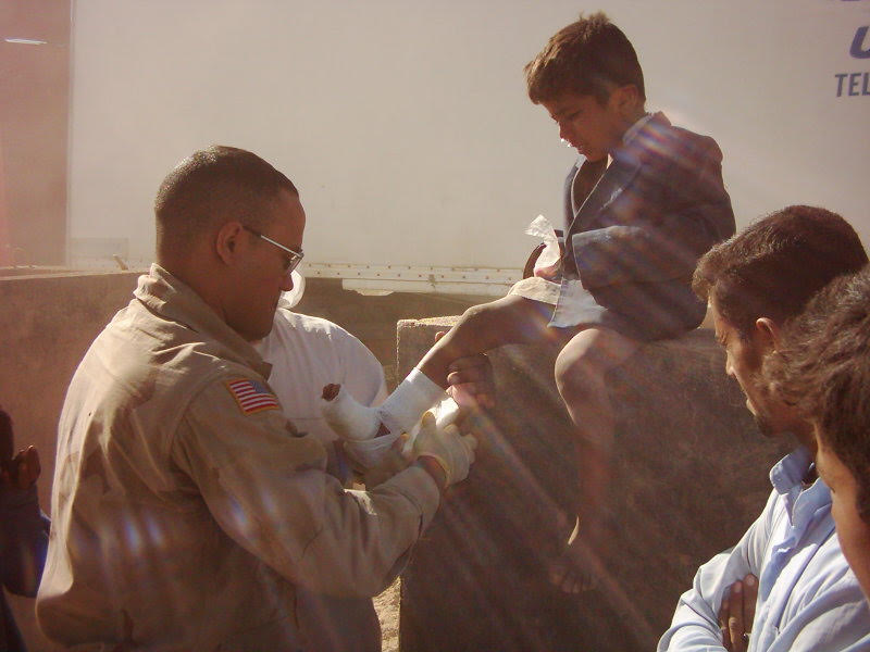 Sgt. Melendez, a combat medic, tending to a child during deployment